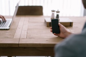 person-smartphone-office-table-highres